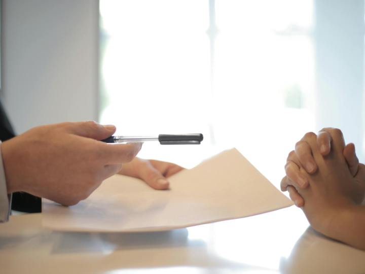 crop businessman giving contract to woman to sign