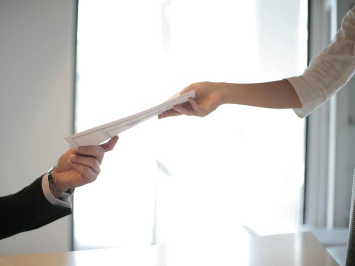 job applicant passing her documents