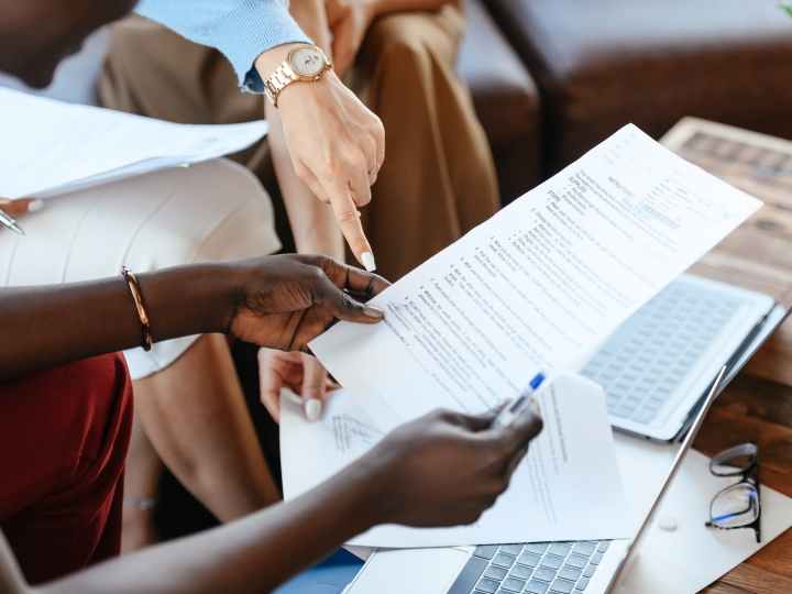 multiethnic businesswomen checking information in documents